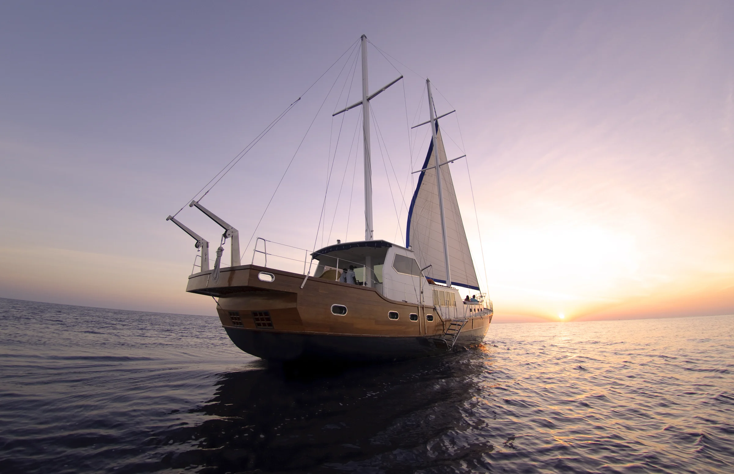 Ocean Whisperer yacht at sunset, Anantara Kihavah