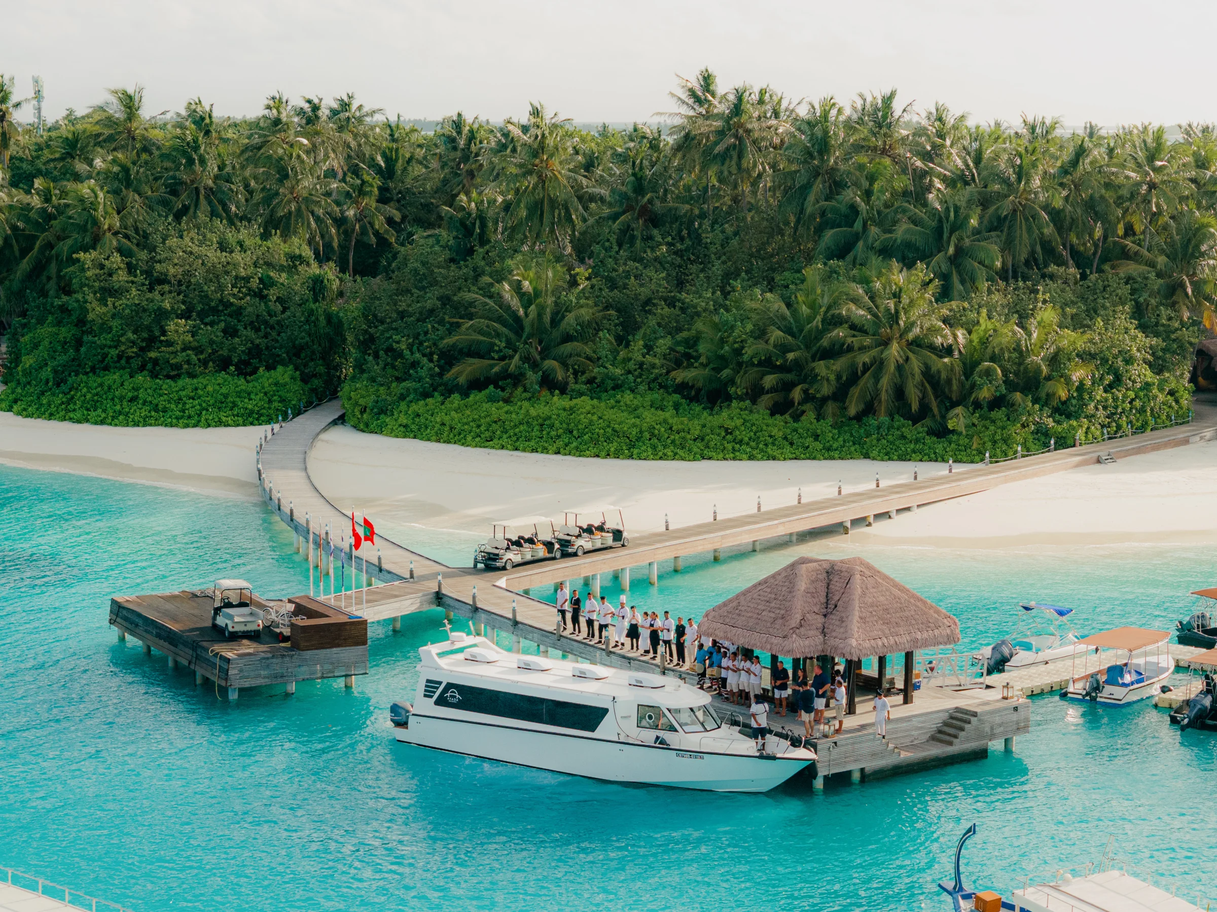 Staff welcoming guests at the arrival jetty, Ayada Maldives