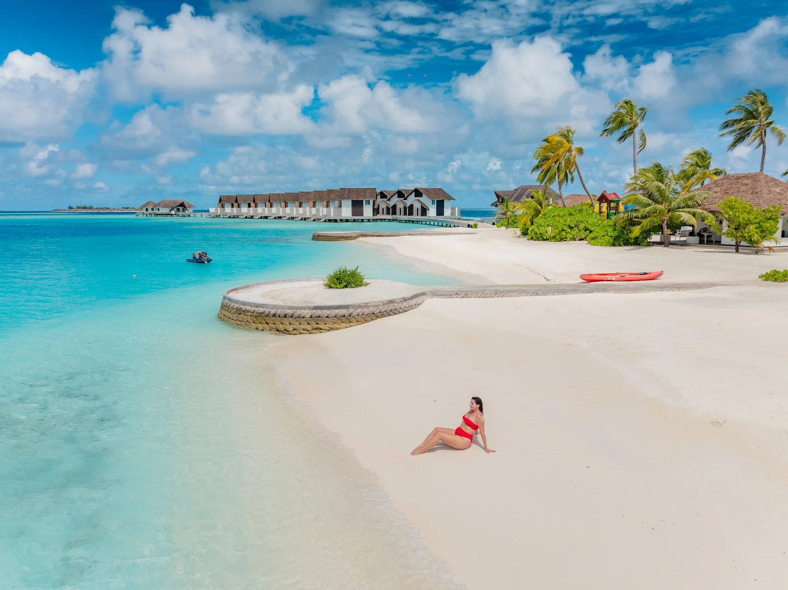 Woman sunbathing on the beach, NOOE Maldives Kunaavashi