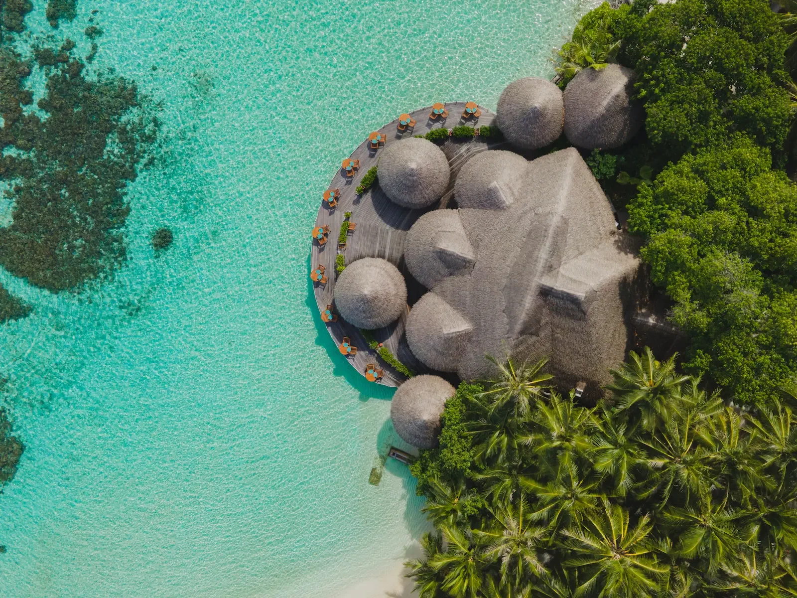 Aerial view of a thatched overwater restaurant, Baros Maldives