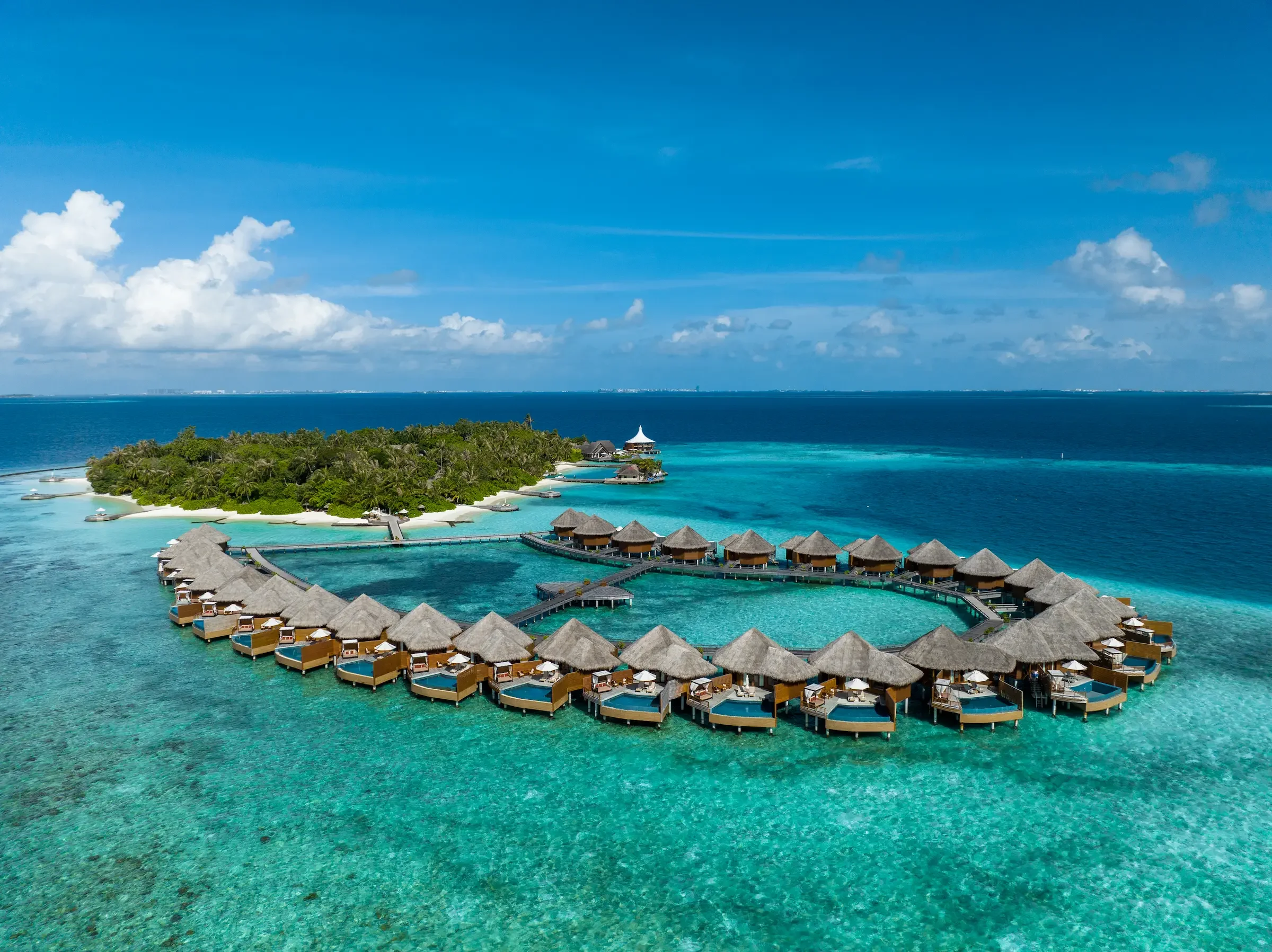The island and its ring of water villas, Baros Maldives