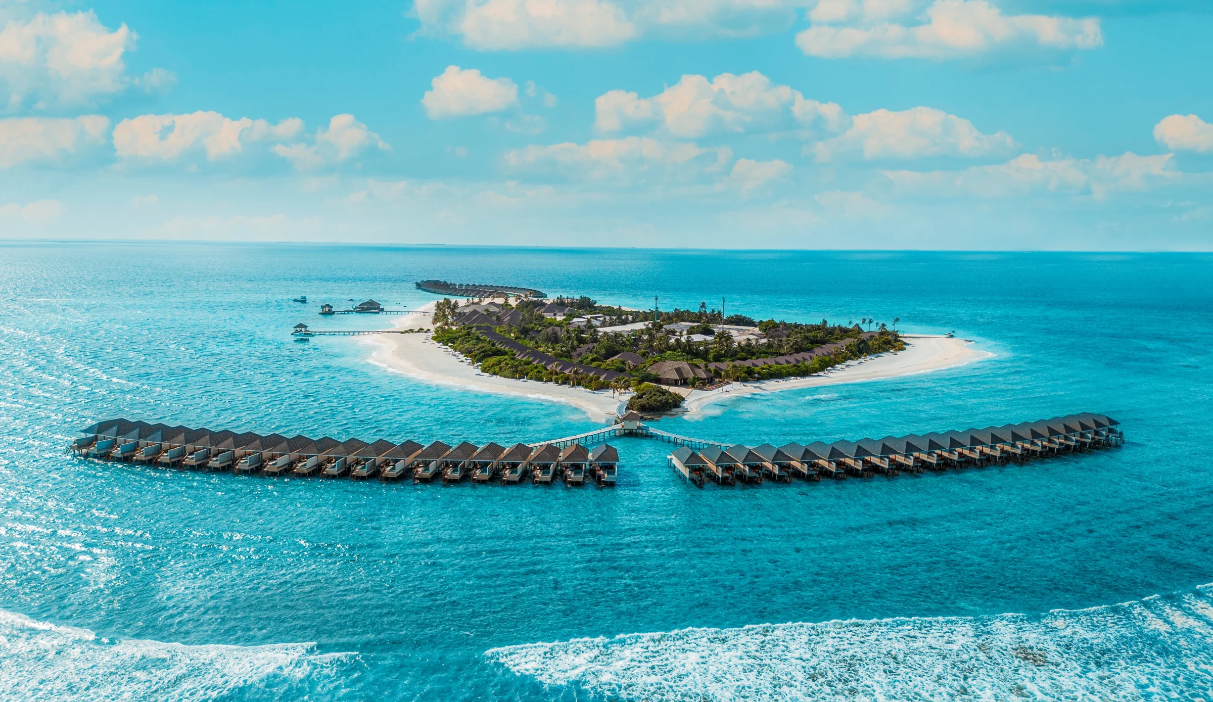 Aerial view of the island and overwater villas, Brennia Kottefaru