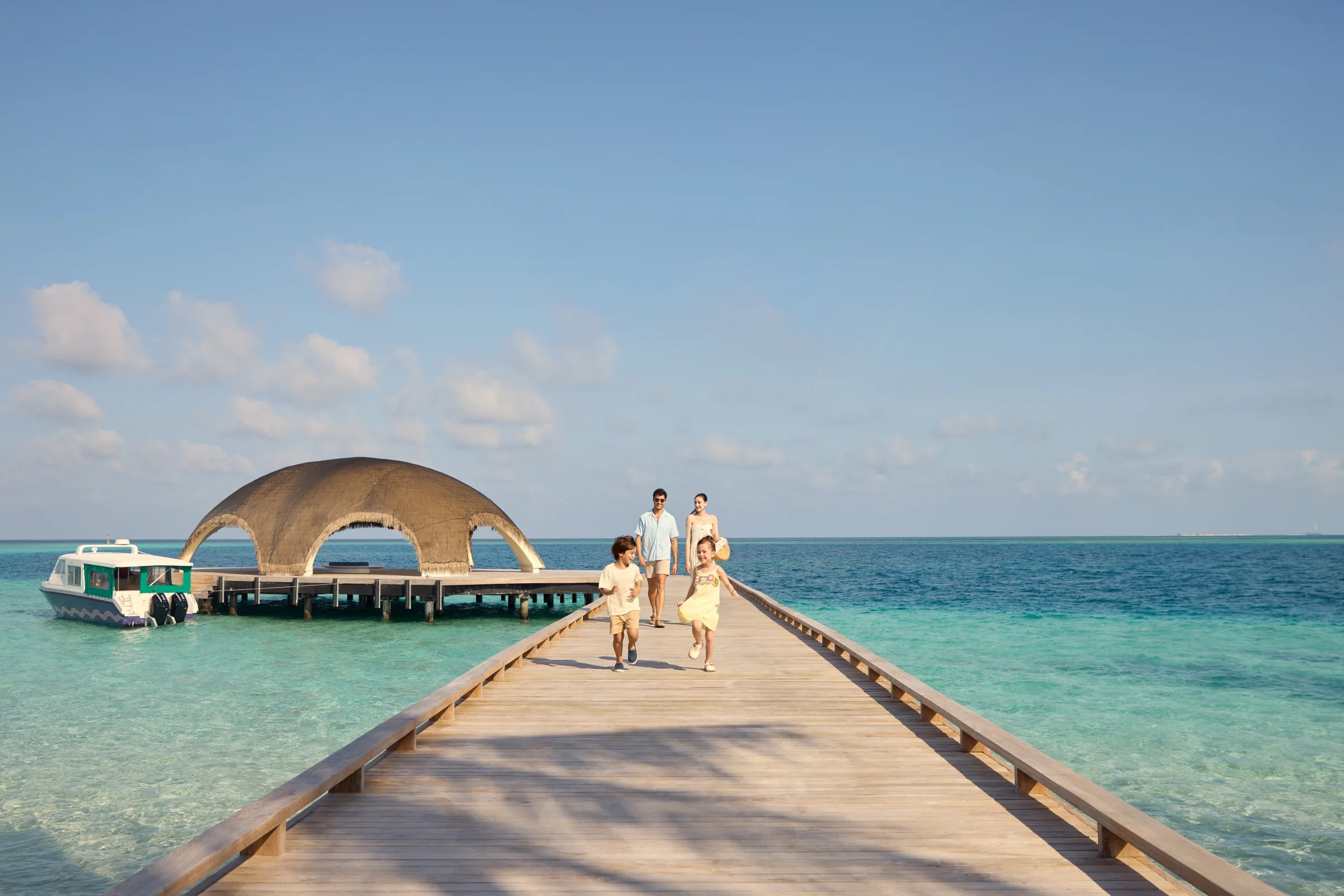 Family on the arrival jetty, Centara Mirage Lagoon Maldives