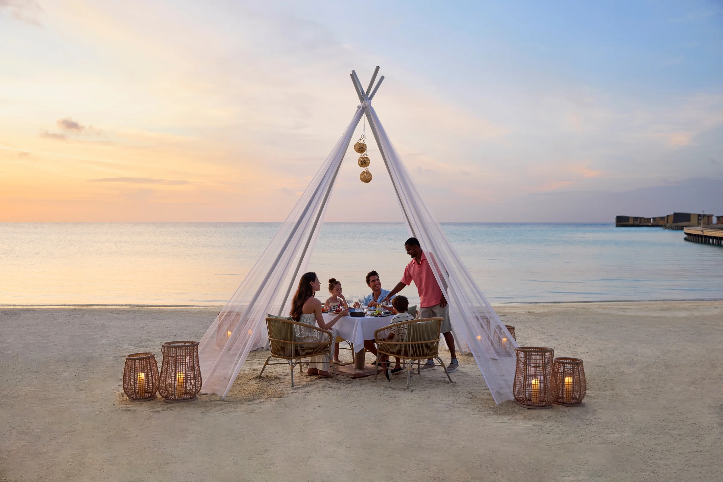 Family dinner on the beach at sunset, Centara Mirage Lagoon Maldives