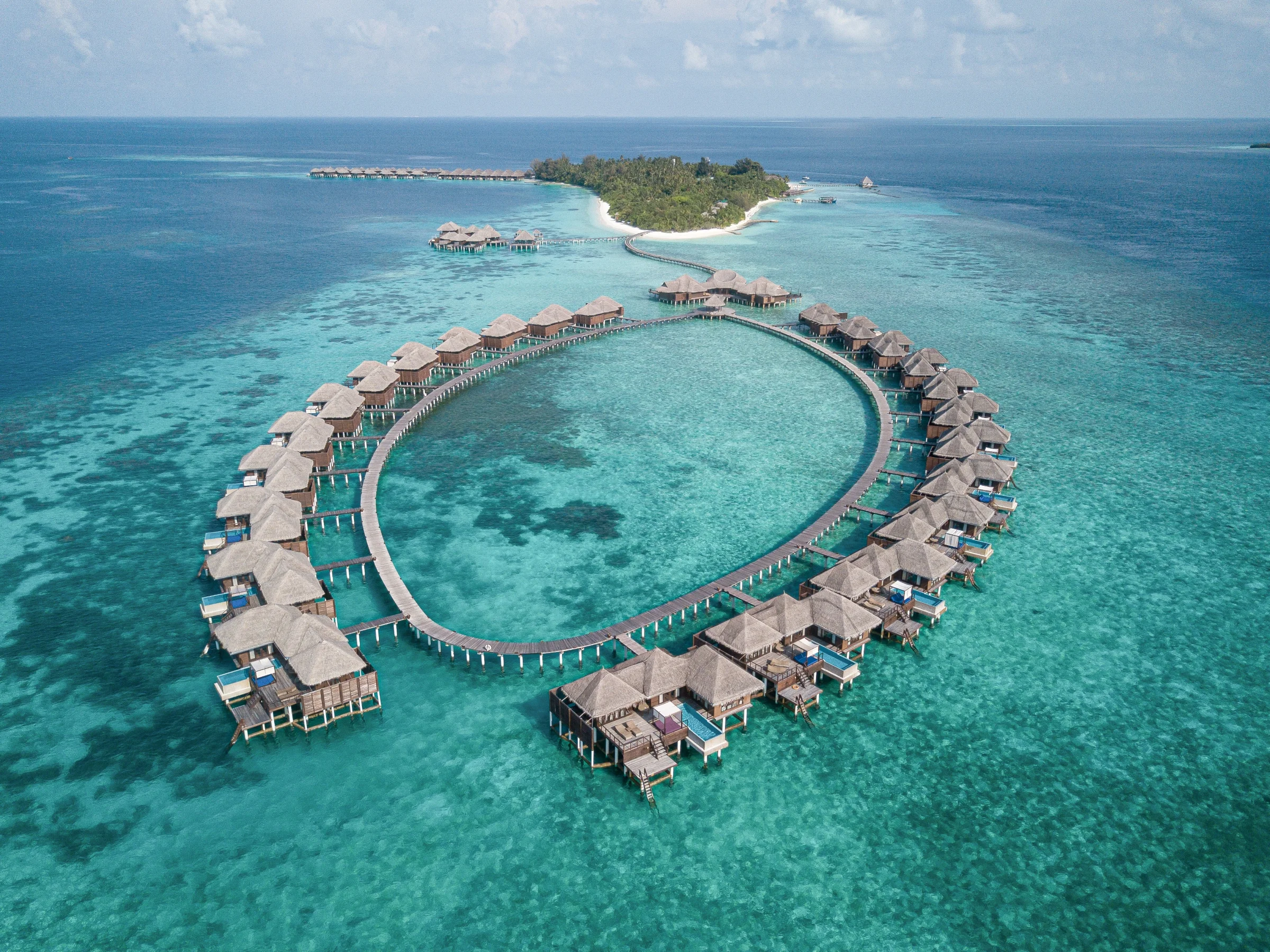 Aerial view of the island and overwater villas, Coco Bodu Hithi