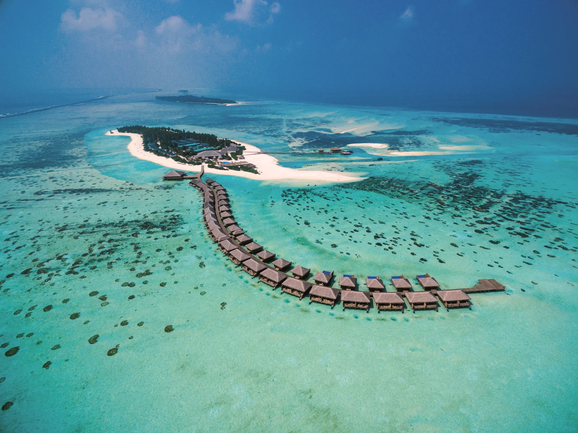 Aerial view of the island and overwater villas, Cocoon Maldives