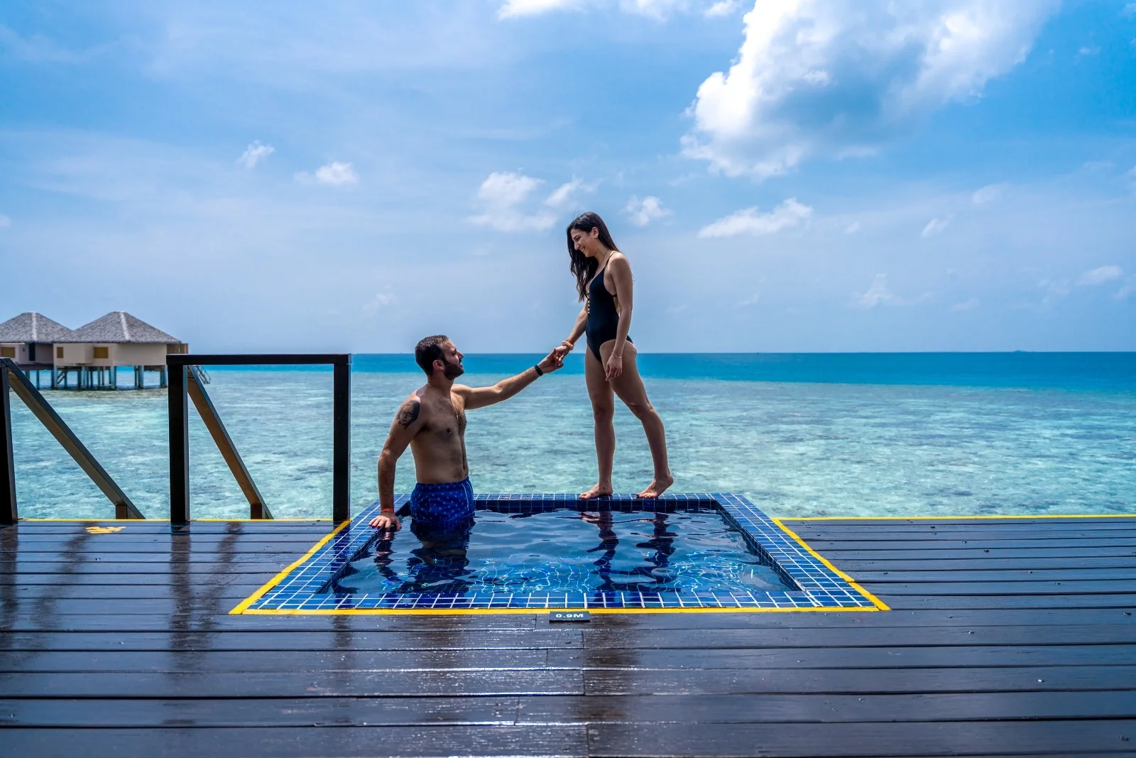Couple at their water villa pool, Adaaran Prestige Vadoo