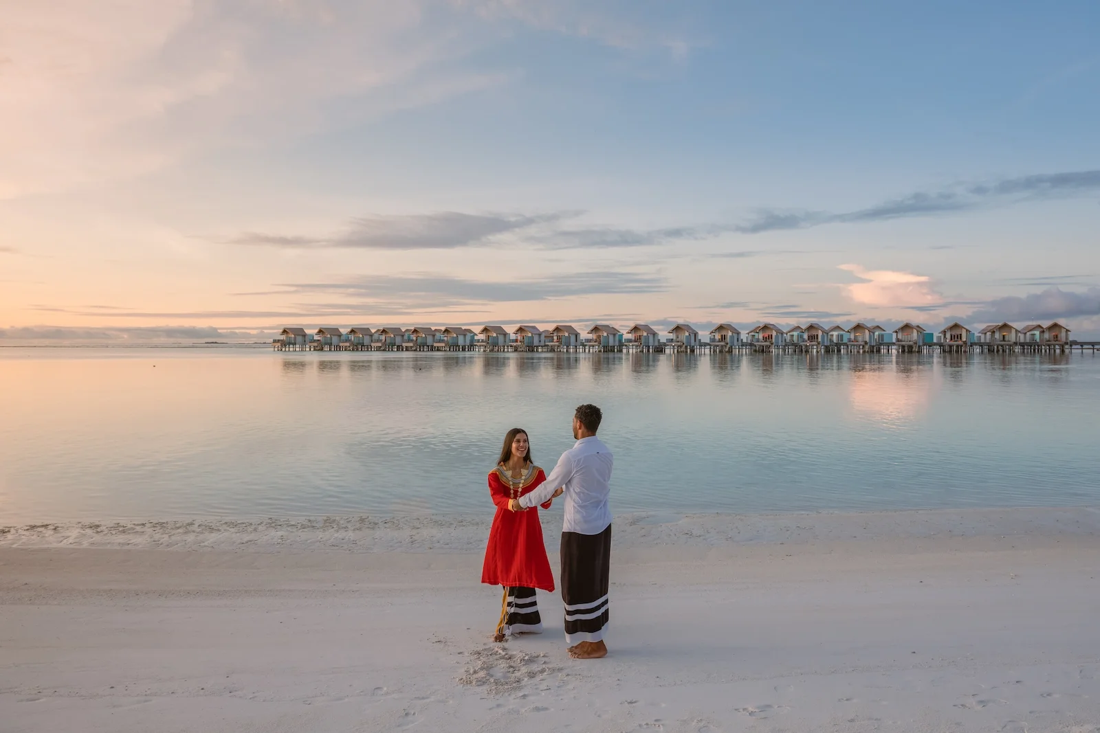 Couple on the beach at sunset, Hard Rock Hotel Maldives