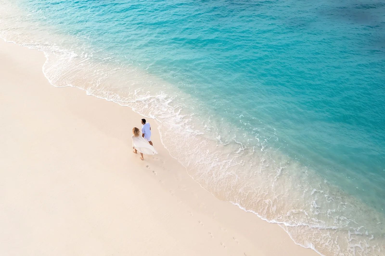 Couple walking on the beach, Joali Being