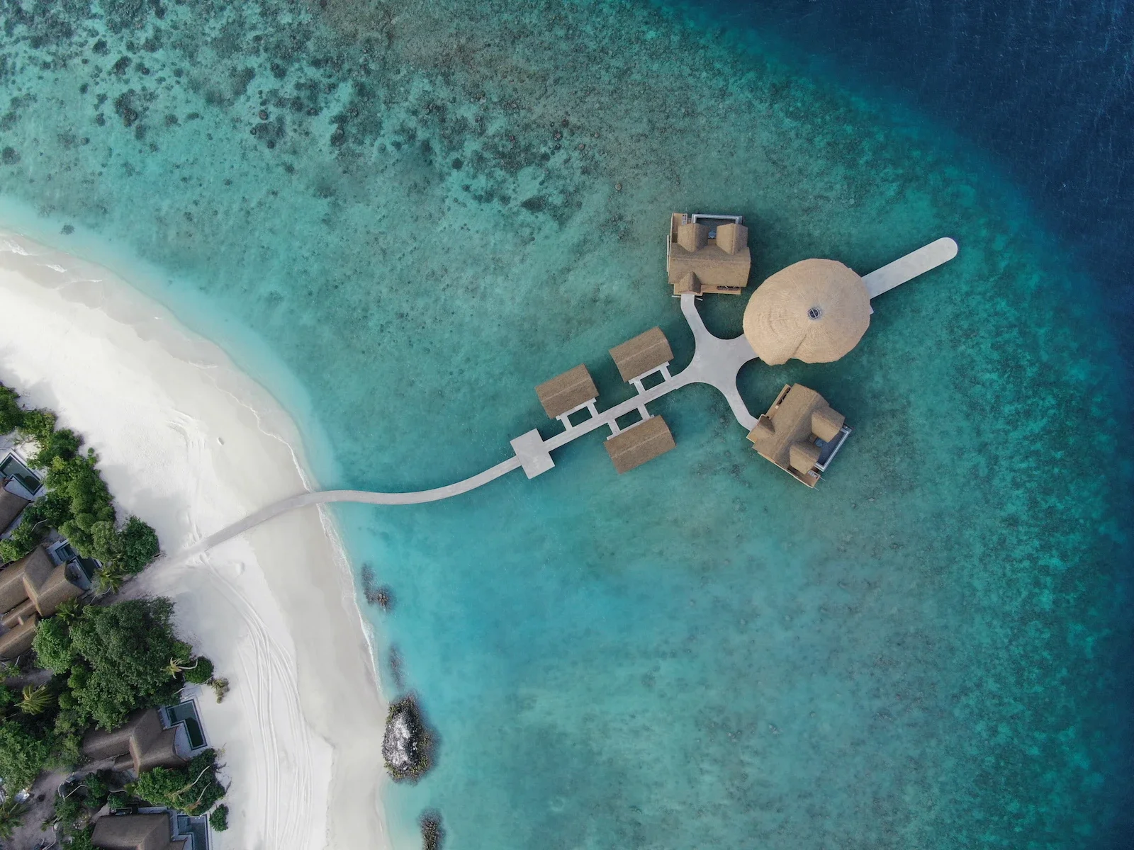 Top-down view of a jetty and overwater pavilions, Joali Being