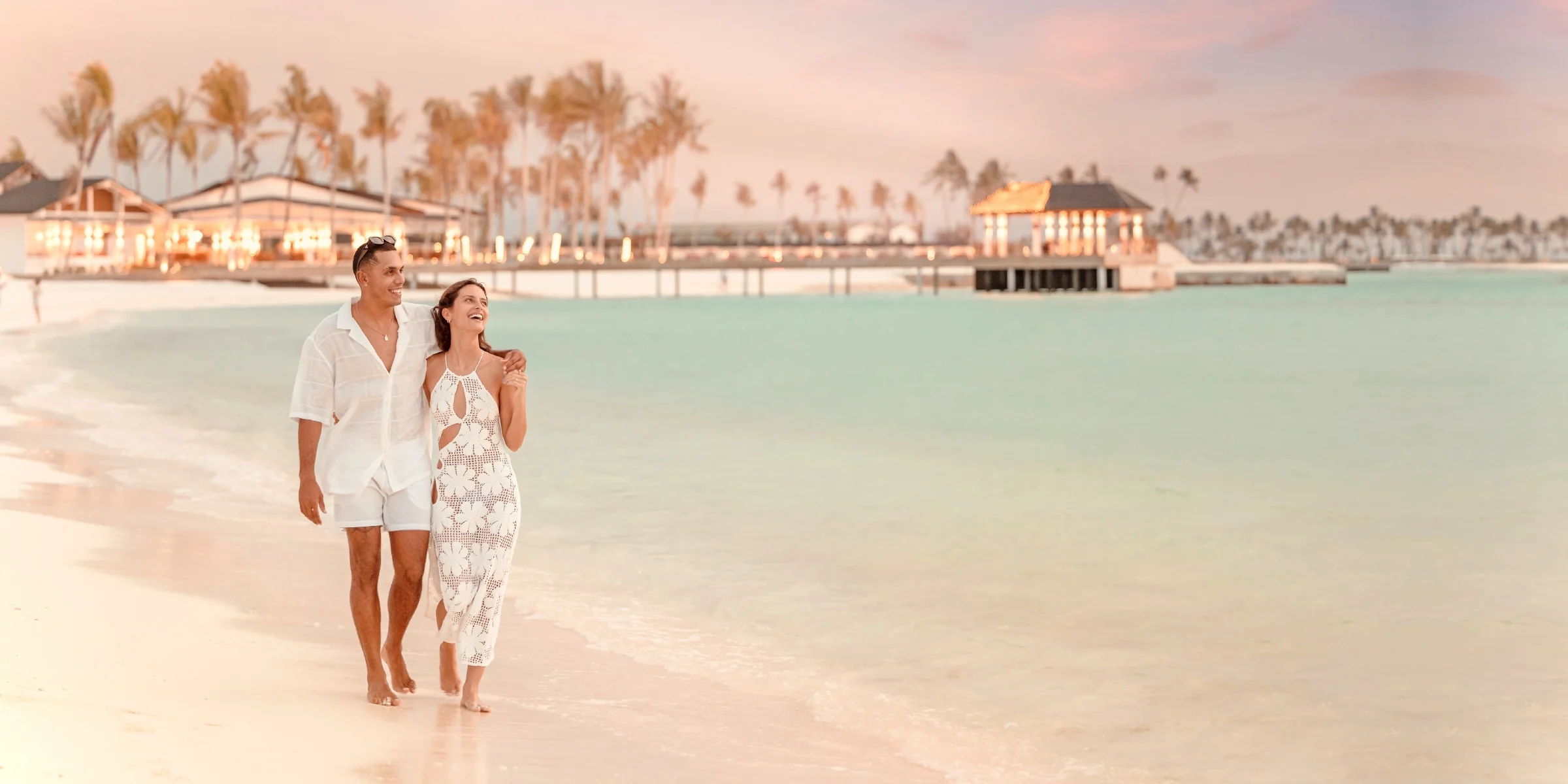 Couple walking on the beach at sunset, Joy Island by Cocoon
