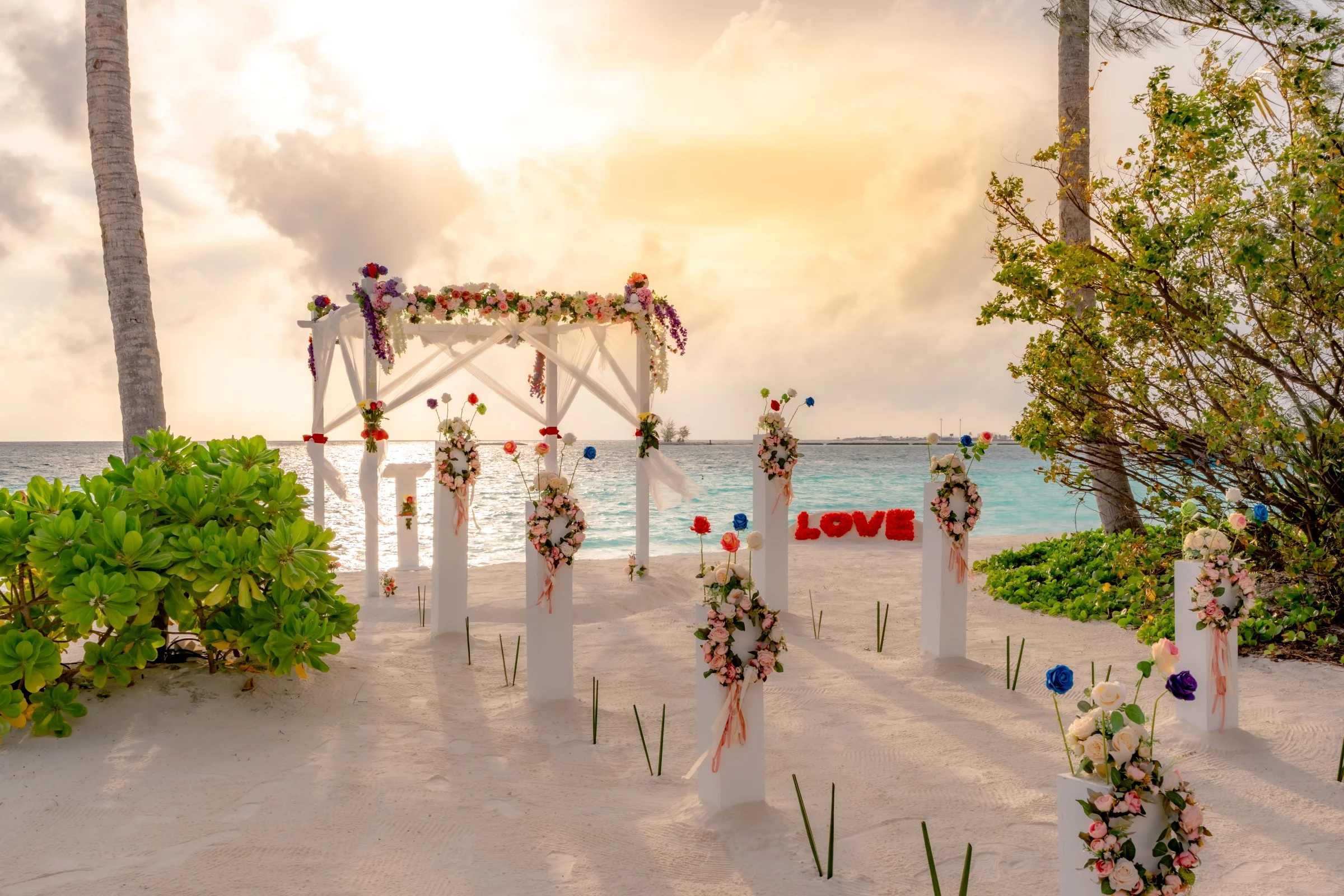 Beach wedding setup with flowers, Joy Island by Cocoon