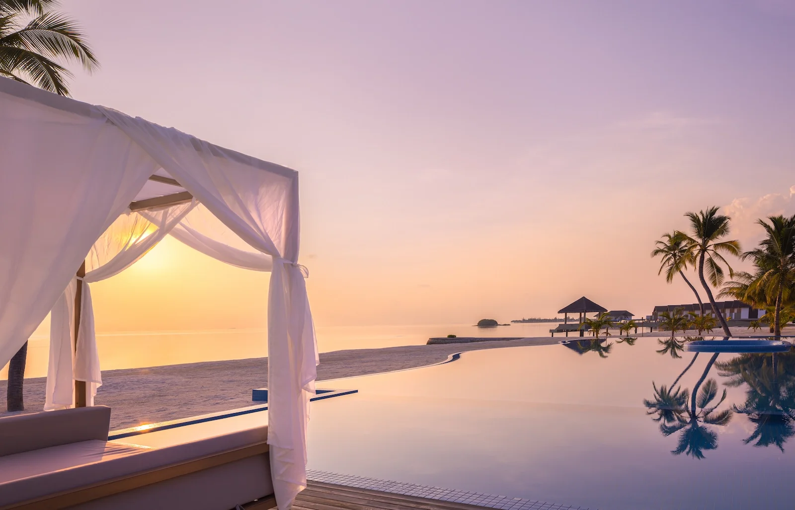 Infinity pool with a cabana at sunset, NOOE Maldives Kunaavashi