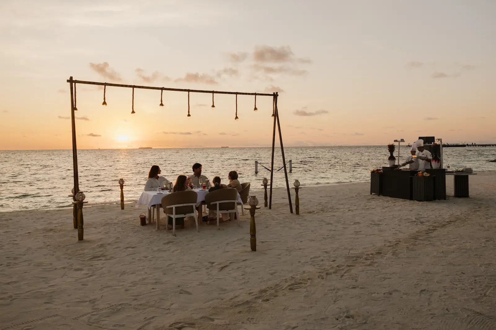 Family dinner on the beach at sunset, Sun Siyam Olhuveli