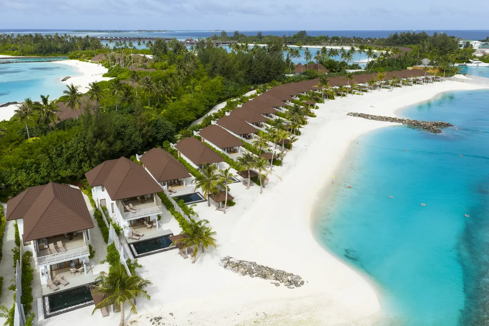 Aerial view of beach villas along the shore, Sun Siyam Olhuveli