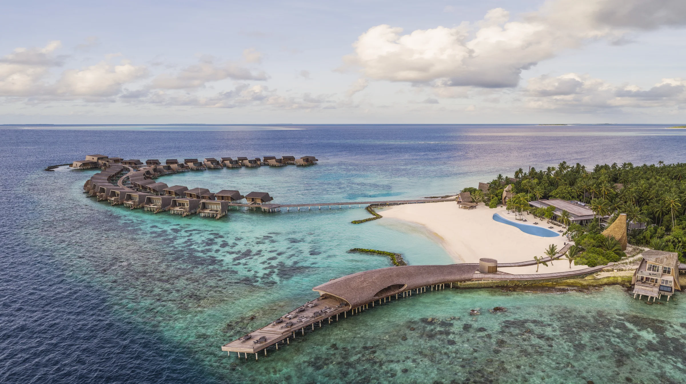 Aerial view of the island and overwater villas, The St Regis Maldives Vommuli