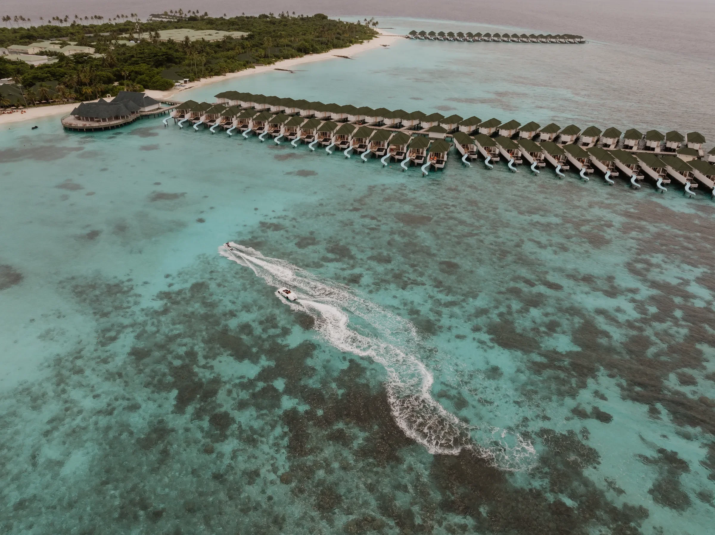 Aerial view of the water villas and a jet ski, Siyam World Maldives