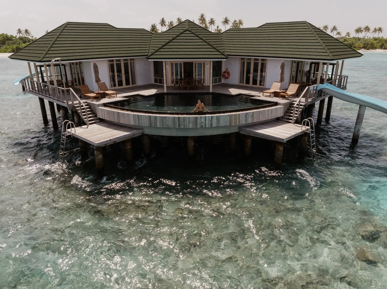 Water villa with a pool and a slide into the lagoon, Siyam World Maldives