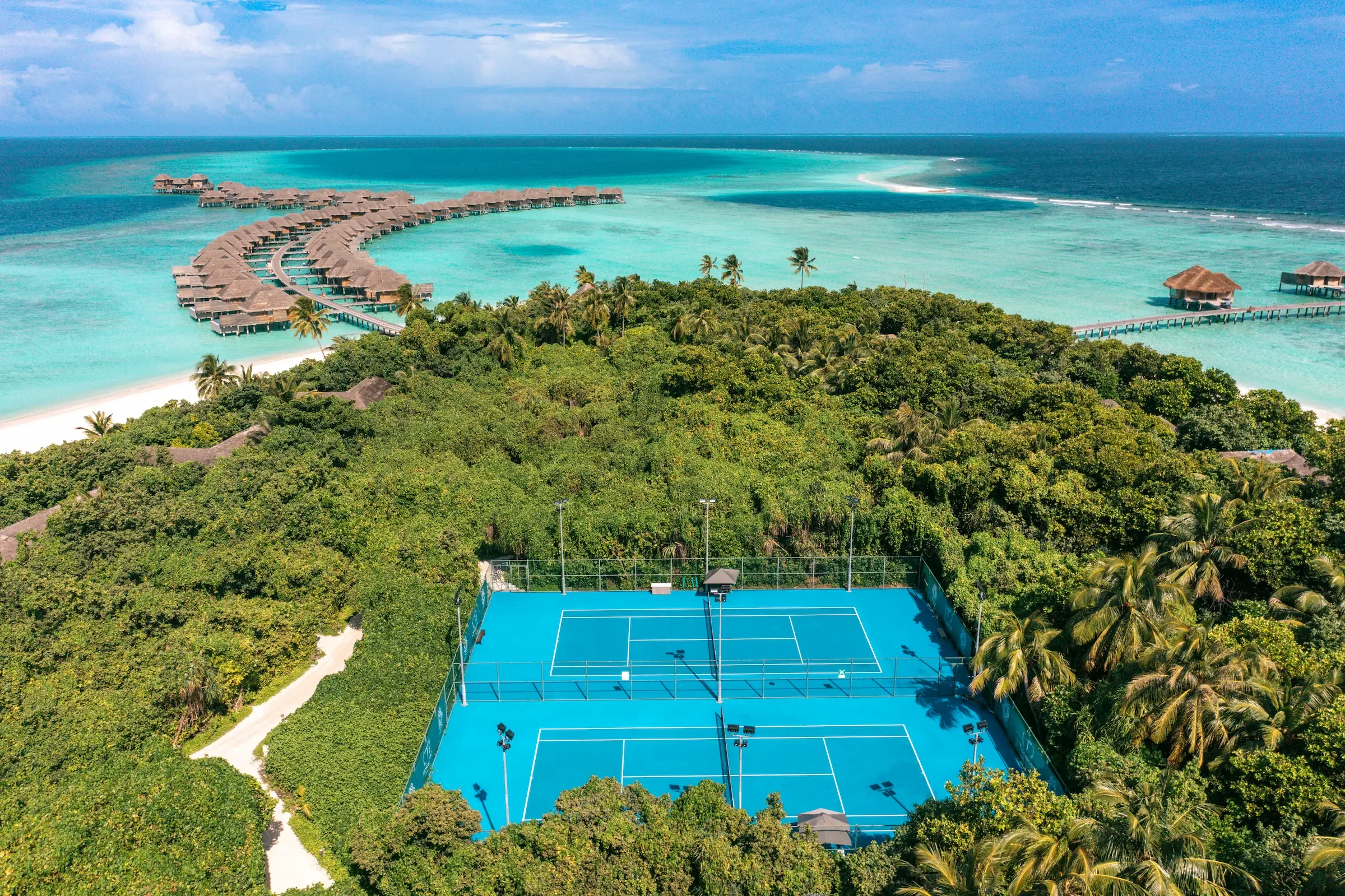 Aerial view of the tennis courts and water villas, Vakkaru Maldives