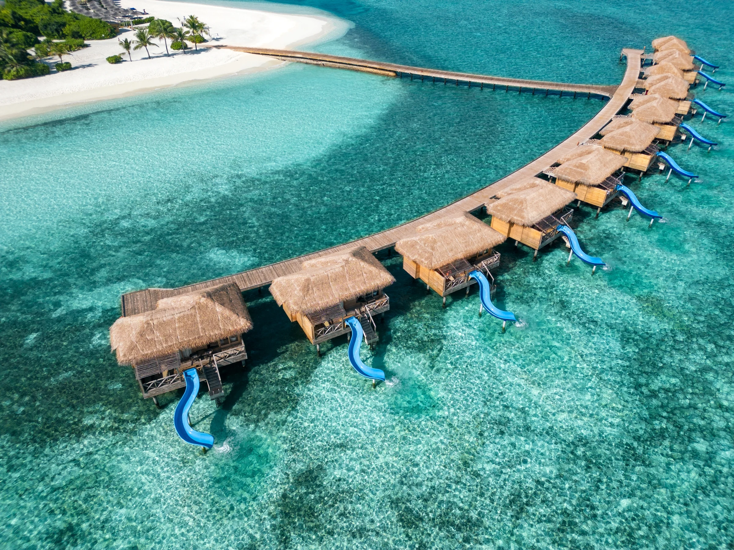 Aerial view of the overwater villas with slides, You&Me by Cocoon
